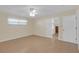 Bedroom features view to closet and access to a private bathroom with tile floors at 12817 Lake Tree Ln, Hudson, FL 34669
