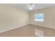 Neutral bedroom features ceiling fan, light, and one window with tan walls at 12817 Lake Tree Ln, Hudson, FL 34669