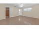 Bedroom showing access to walk in closet, bathroom, and neutral color scheme at 12817 Lake Tree Ln, Hudson, FL 34669