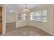 Cozy dining space with arched details and view of the kitchen at 12817 Lake Tree Ln, Hudson, FL 34669