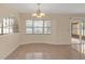 Bright dining area with large windows and tile flooring at 12817 Lake Tree Ln, Hudson, FL 34669
