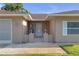 Inviting covered entrance featuring unique white metalwork and textured facade at 12817 Lake Tree Ln, Hudson, FL 34669