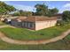 Charming single-story home with a lush green lawn, mature trees, and a well-maintained yard at 12817 Lake Tree Ln, Hudson, FL 34669