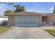 A well-maintained single-story home with a two-car garage and a paved driveway at 12817 Lake Tree Ln, Hudson, FL 34669