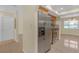 Kitchen with stainless steel refrigerator adjacent to breakfast nook at 12817 Lake Tree Ln, Hudson, FL 34669