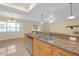 Open kitchen with granite countertops, stainless steel appliances and breakfast bar overlooking living area at 12817 Lake Tree Ln, Hudson, FL 34669