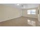 Bright, open living room with tile flooring and plenty of natural light at 12817 Lake Tree Ln, Hudson, FL 34669