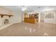 Open-concept living room next to kitchen featuring a fireplace at 12817 Lake Tree Ln, Hudson, FL 34669