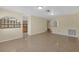 Open-concept living area featuring tile flooring, neutral walls, and arched accents at 12817 Lake Tree Ln, Hudson, FL 34669