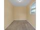 Bright room featuring fresh paint, concrete floors, and a large window looking out onto the yard at 12817 Lake Tree Ln, Hudson, FL 34669
