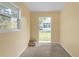 Bright room featuring fresh paint, concrete floors, and large windows looking out onto the yard at 12817 Lake Tree Ln, Hudson, FL 34669