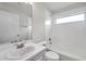 Bright bathroom features a shower-tub combo and modern vanity at 1408 Birchstone Ave, Brandon, FL 33511