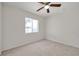 Bedroom features neutral carpet, a ceiling fan and a bright window at 1408 Birchstone Ave, Brandon, FL 33511