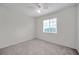 Bedroom features neutral carpet, a ceiling fan and a bright window at 1408 Birchstone Ave, Brandon, FL 33511