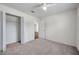 Well-lit bedroom features neutral carpet, a ceiling fan and a walk-in closet at 1408 Birchstone Ave, Brandon, FL 33511