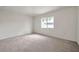 An empty room with carpet flooring, white walls, and a window view at 1408 Birchstone Ave, Brandon, FL 33511