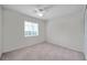 A bedroom with carpet flooring, a ceiling fan, and a window view at 1408 Birchstone Ave, Brandon, FL 33511