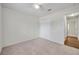 Bright bedroom features neutral carpet, a ceiling fan and a spacious closet at 1408 Birchstone Ave, Brandon, FL 33511