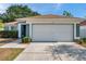 Charming single-story home features a two-car garage, well-maintained landscaping, and neutral color palette at 1408 Birchstone Ave, Brandon, FL 33511
