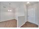 Bright foyer with hardwood floors, modern light fixtures, and freshly painted walls at 1408 Birchstone Ave, Brandon, FL 33511