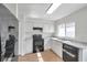 Bright kitchen features white cabinets, black appliances, and wood-look flooring at 1408 Birchstone Ave, Brandon, FL 33511