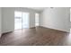 Spacious living room featuring wood flooring and sliding glass door access to patio at 1408 Birchstone Ave, Brandon, FL 33511