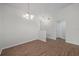 Inviting living room featuring new wood floors, neutral walls, and chandelier with open floor plan at 1408 Birchstone Ave, Brandon, FL 33511