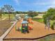 A community playground with a playset with slides, swings, and wood chip safety ground cover at 1408 Birchstone Ave, Brandon, FL 33511