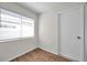 A bright room with wood-look flooring and a window with blinds at 1408 Birchstone Ave, Brandon, FL 33511