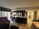 A spacious living room with a breakfast bar and views to a doorway leading to other rooms at 1445 72Nd Ne Ave, St Petersburg, FL 33702