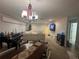 Large open-concept living and dining space with modern lighting and neutral decor at 1445 72Nd Ne Ave, St Petersburg, FL 33702