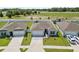 Aerial view of three homes, fenced backyards, driveways and well manicured front lawns at 14498 Whitewater Way, Brooksville, FL 34604