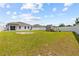 Large grassy backyard with a view of the house, and a storage building at 14498 Whitewater Way, Brooksville, FL 34604