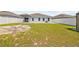 A large backyard with a new fence, view of the back patio and yard building at 14498 Whitewater Way, Brooksville, FL 34604