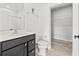 Bathroom with black vanity, tile flooring, and access to walk in closet at 14498 Whitewater Way, Brooksville, FL 34604