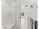 Bright bathroom featuring a tiled shower with modern fixtures and a doorway to the bedroom at 14498 Whitewater Way, Brooksville, FL 34604
