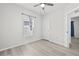 Light and airy bedroom with ceiling fan, light-colored wood-look flooring, and plenty of natural light at 14498 Whitewater Way, Brooksville, FL 34604