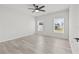 This bedroom has a neutral color palette, wood-look floors and two windows at 14498 Whitewater Way, Brooksville, FL 34604