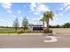Suncoast Landing community entrance sign with palm trees and well-maintained landscaping on a bright, sunny day at 14498 Whitewater Way, Brooksville, FL 34604