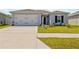 Charming single-story home with a well-manicured lawn, two car garage, and a welcoming entrance at 14498 Whitewater Way, Brooksville, FL 34604