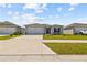 Inviting single-story home featuring a two-car garage, neat landscaping, and a pleasant curb appeal at 14498 Whitewater Way, Brooksville, FL 34604