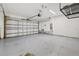 Spacious garage with epoxy flooring, shelving and an automatic door opener at 14498 Whitewater Way, Brooksville, FL 34604