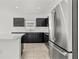 Contemporary kitchen featuring stainless steel appliances, a central island, and ample counter space at 14498 Whitewater Way, Brooksville, FL 34604