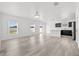 Open-concept living area with wood floors, abundant natural light, and views of the kitchen at 14498 Whitewater Way, Brooksville, FL 34604