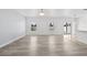 Spacious living room with wood flooring, abundant natural light, and an open floor plan at 14498 Whitewater Way, Brooksville, FL 34604