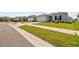 Exterior street view showcasing the home's manicured lawn and neighborhood setting, with similar-style houses at 14498 Whitewater Way, Brooksville, FL 34604