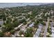 Residential aerial view showcasing a neighborhood with tree-lined streets and a glimpse of a body of water in the distance at 1526 San Mateo Dr, Dunedin, FL 34698