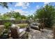 Lush backyard featuring a cozy patio seating area with stylish furniture, surrounded by greenery at 1526 San Mateo Dr, Dunedin, FL 34698