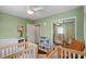 Inviting Bedroom with a neutral color scheme, twin cribs, and a comfortable armchair at 1526 San Mateo Dr, Dunedin, FL 34698
