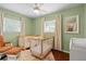 Charming Bedroom featuring two cozy cribs and soft, natural light, perfect for a peaceful environment at 1526 San Mateo Dr, Dunedin, FL 34698